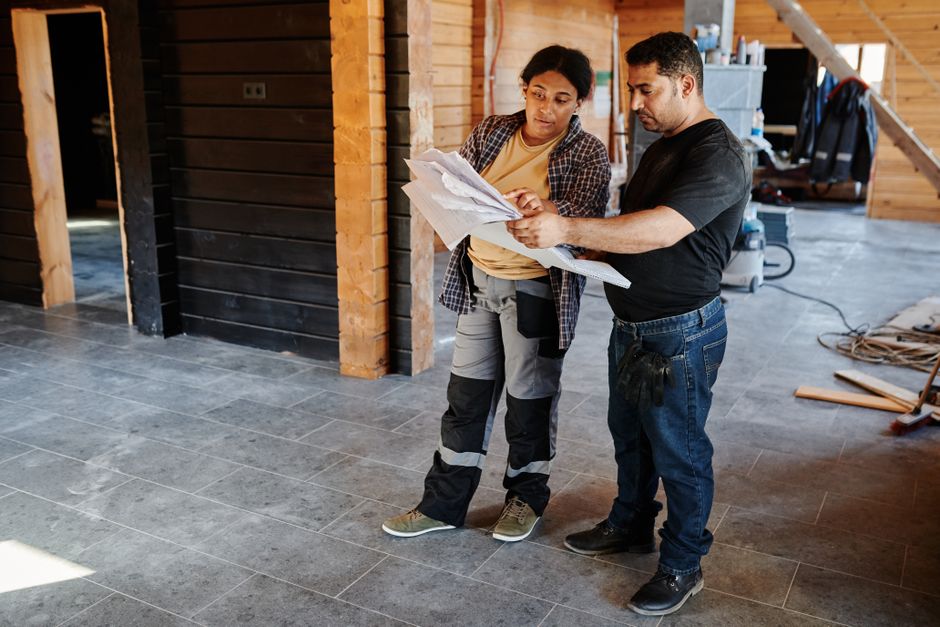 Contractor reviewing kitchen remodeling blueprints